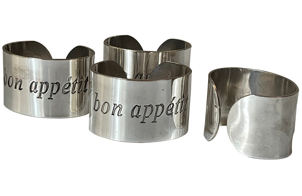 Set of four decorative napkin holders with Bon Appétit inscribed to each.