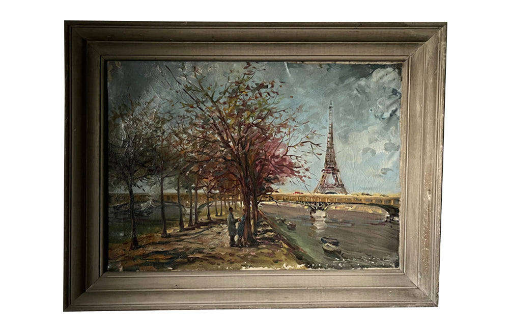 20th century signed, unrestored oil on canvas painting of the Eiffel Tower with a pair of Parisian lovers under an avenue of trees in Autumnal leaf along the River Seine.