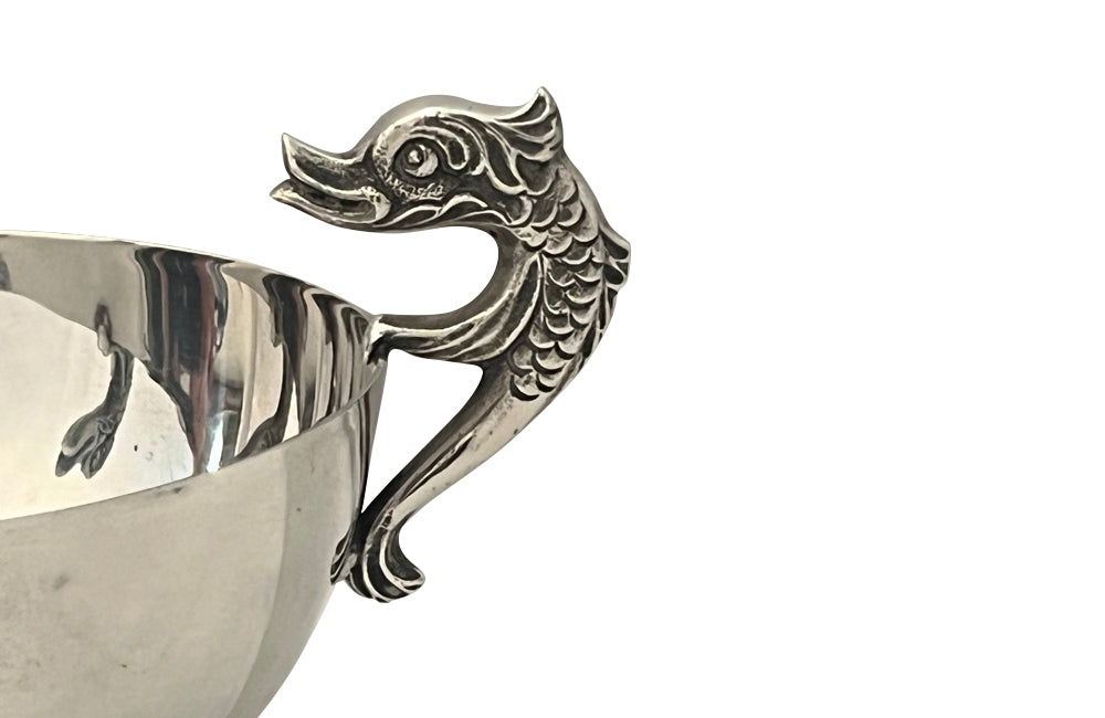 Decorative silver plate bowl with dolphin handles on raised foot and stamped with makers mark B.R.