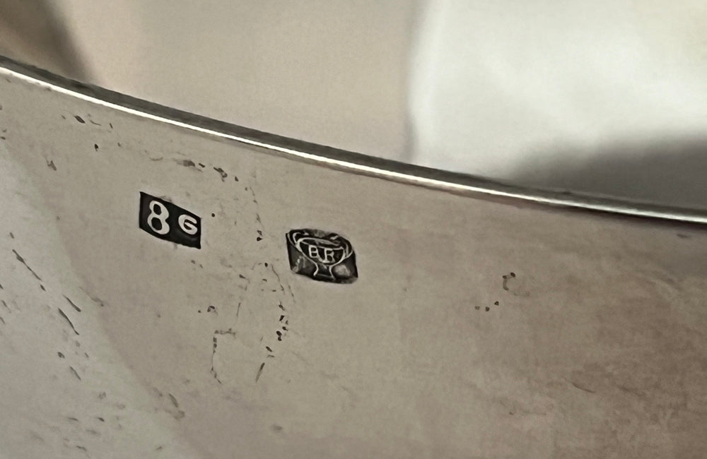 Decorative silver plate bowl with dolphin handles on raised foot and stamped with makers mark B.R.