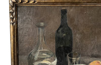Lovely, French still life painting of fried eggs in a pan, a carafe of water, bottle of wine, glass, loaf of bread, ceramic cup and cloth napkin.