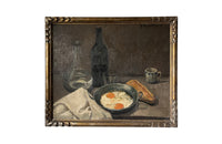 Lovely, French still life painting of fried eggs in a pan, a carafe of water, bottle of wine, glass, loaf of bread, ceramic cup and cloth napkin.