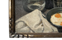 Lovely, French still life painting of fried eggs in a pan, a carafe of water, bottle of wine, glass, loaf of bread, ceramic cup and cloth napkin.