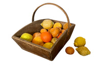 Antique wooden harvest panier filled with marble trompe l'oeil lemons, limes, oranges and mandarins.Italian