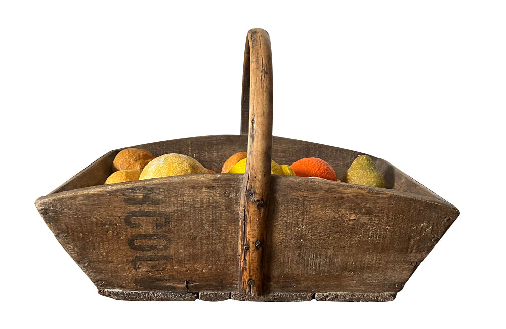 Antique wooden harvest panier filled with marble trompe l'oeil lemons, limes, oranges and mandarins.Italian