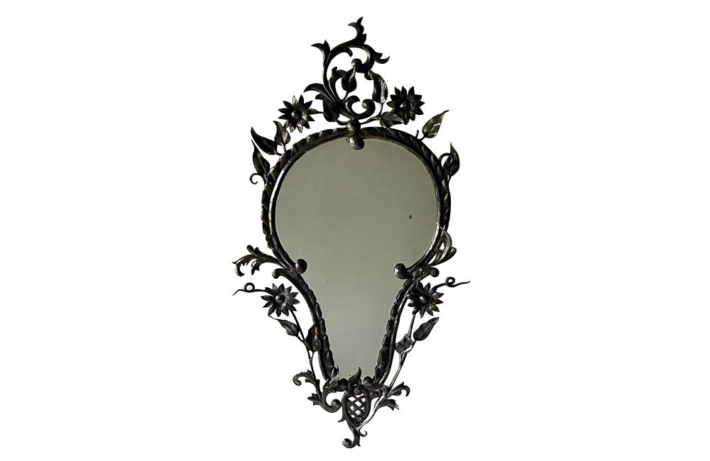 Pretty wrought iron mirror with floral and foliate decoration circa 1900