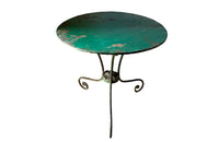 French green iron gueridon with lovely scrolled wrought iron legs and pretty cast iron central floral medallion. Remains of its original layers of paint.