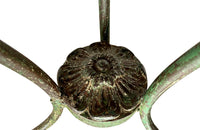 French green iron gueridon with lovely scrolled wrought iron legs and pretty cast iron central floral medallion. Remains of its original layers of paint.