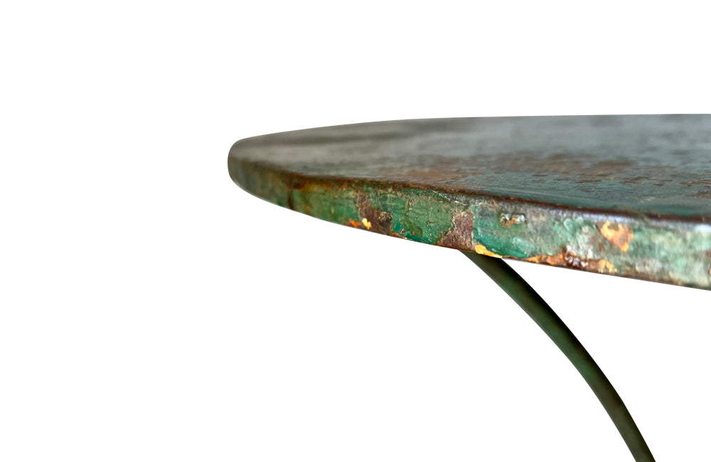 French green iron gueridon with lovely scrolled wrought iron legs and pretty cast iron central floral medallion. Remains of its original layers of paint.