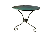 French green iron gueridon with lovely scrolled wrought iron legs and pretty cast iron central floral medallion. Remains of its original layers of paint.