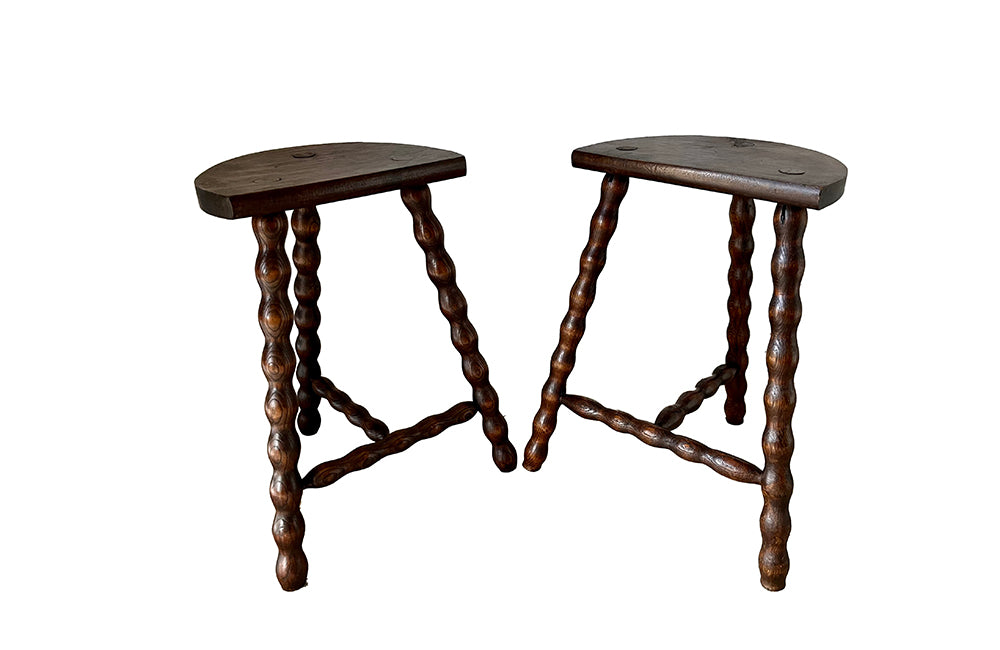 Pair of vintage demi lune tripod stools with bobbin carved legs.