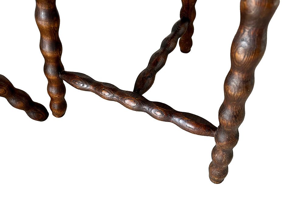 Pair of vintage demi lune tripod stools with bobbin carved legs.
