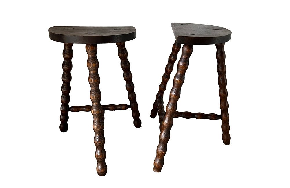 Pair of vintage demi lune tripod stools with bobbin carved legs.