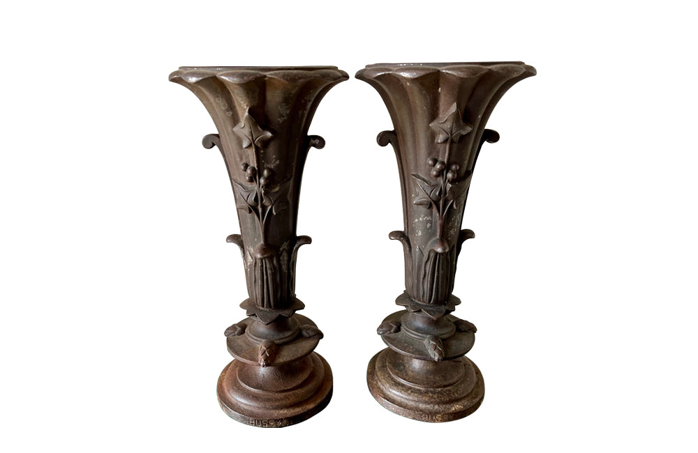 Pair of 19th century French cast iron vases in tulip form with ivy and foliate decoration to both sides. Stamped Bussy.