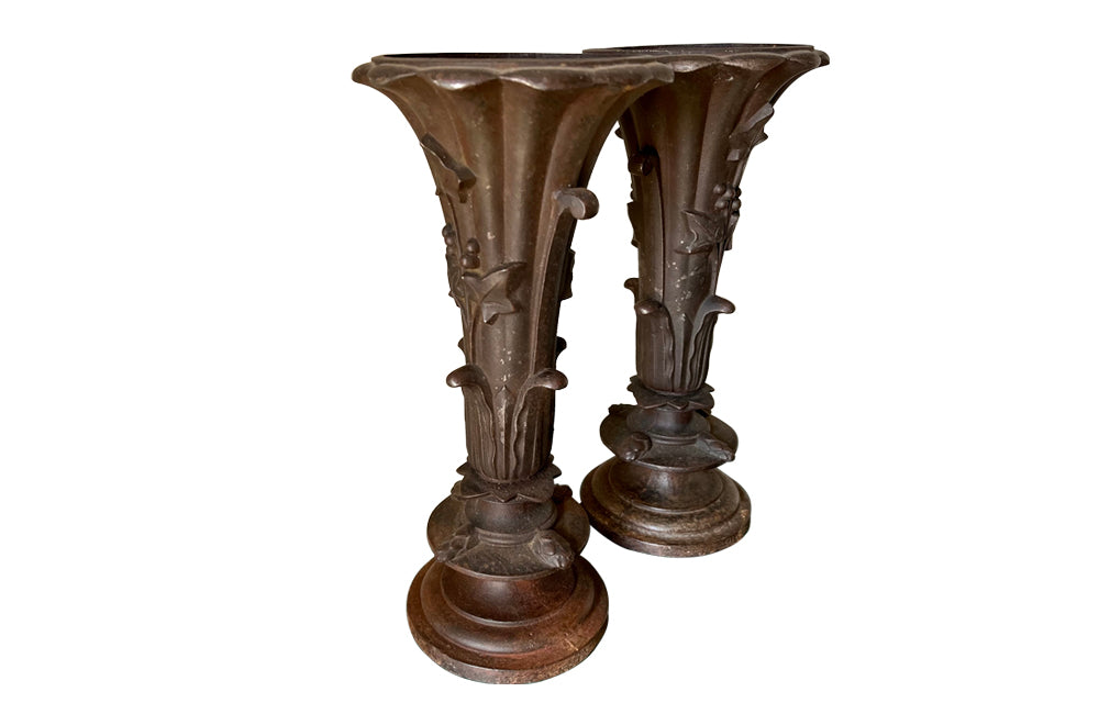 Pair of 19th century French cast iron vases in tulip form with ivy and foliate decoration to both sides. Stamped Bussy.