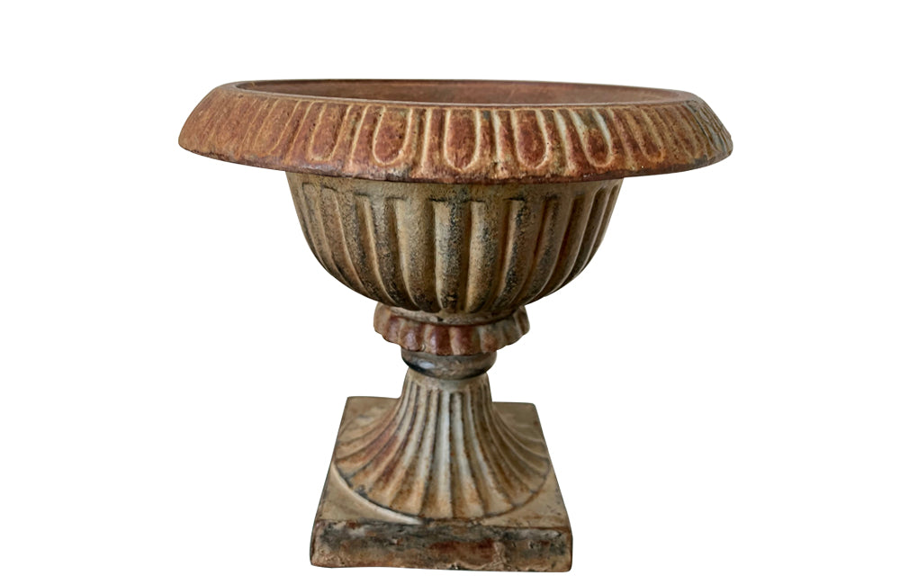 Pair of pretty French cast iron medici garden urns in the Neo-Classical style with traces of original blue paint. Circa 1930