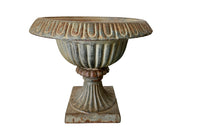 Pair of pretty French cast iron medici garden urns in the Neo-Classical style with traces of original blue paint. Circa 1930