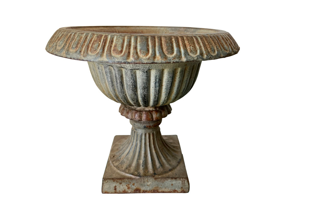 Pair of pretty French cast iron medici garden urns in the Neo-Classical style with traces of original blue paint. Circa 1930