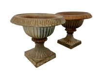 Pair of pretty French cast iron medici garden urns in the Neo-Classical style with traces of original blue paint. Circa 1930