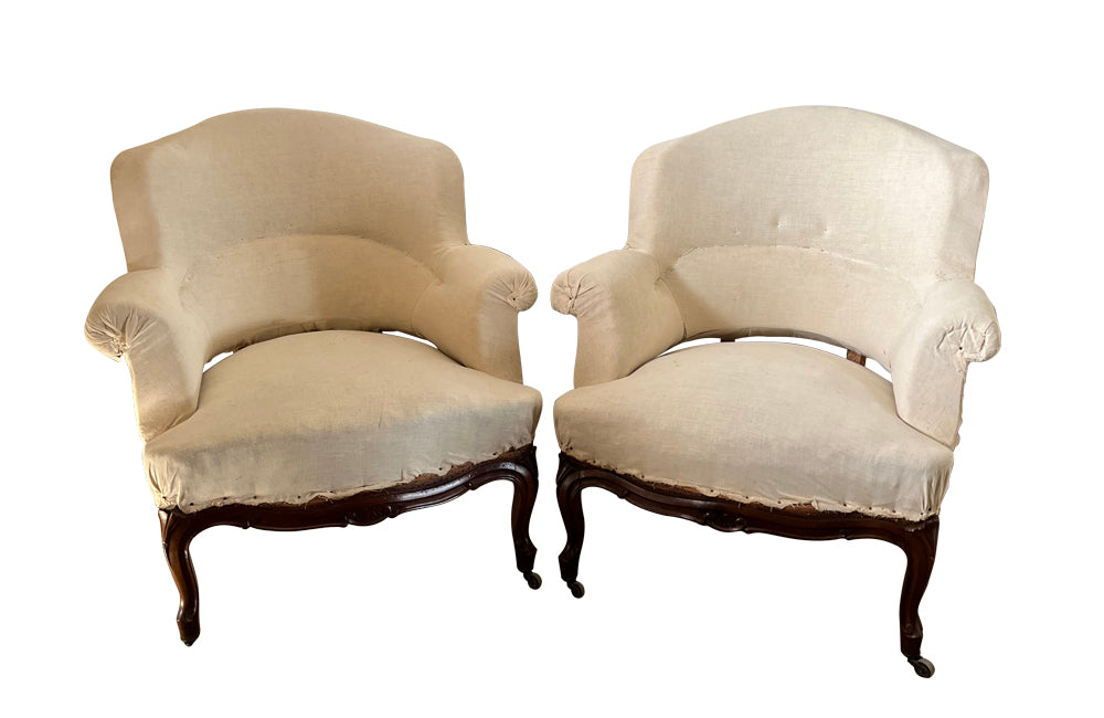 Elegant pair of walnut French armchairs in the Louis XV style.