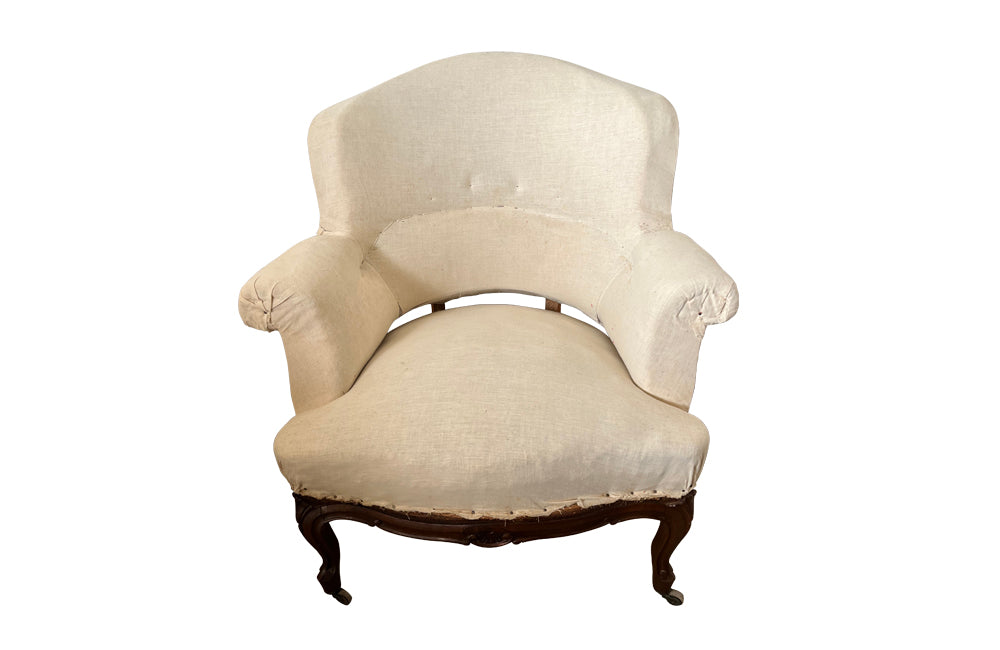 Elegant pair of walnut French armchairs in the Louis XV style.