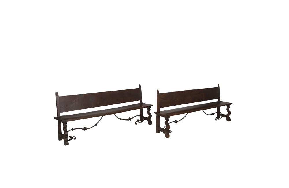 Pair of large Spanish oak benches with backs. Carved legs and decorative wrought iron stretchers.
