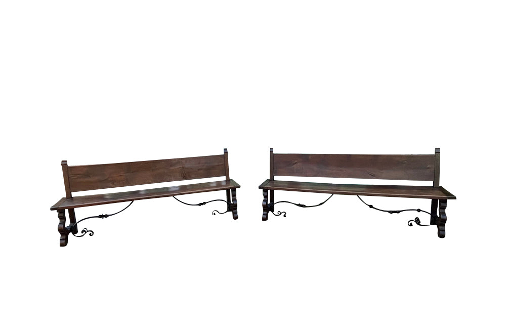 Pair of large Spanish oak benches with backs. Carved legs and decorative wrought iron stretchers.