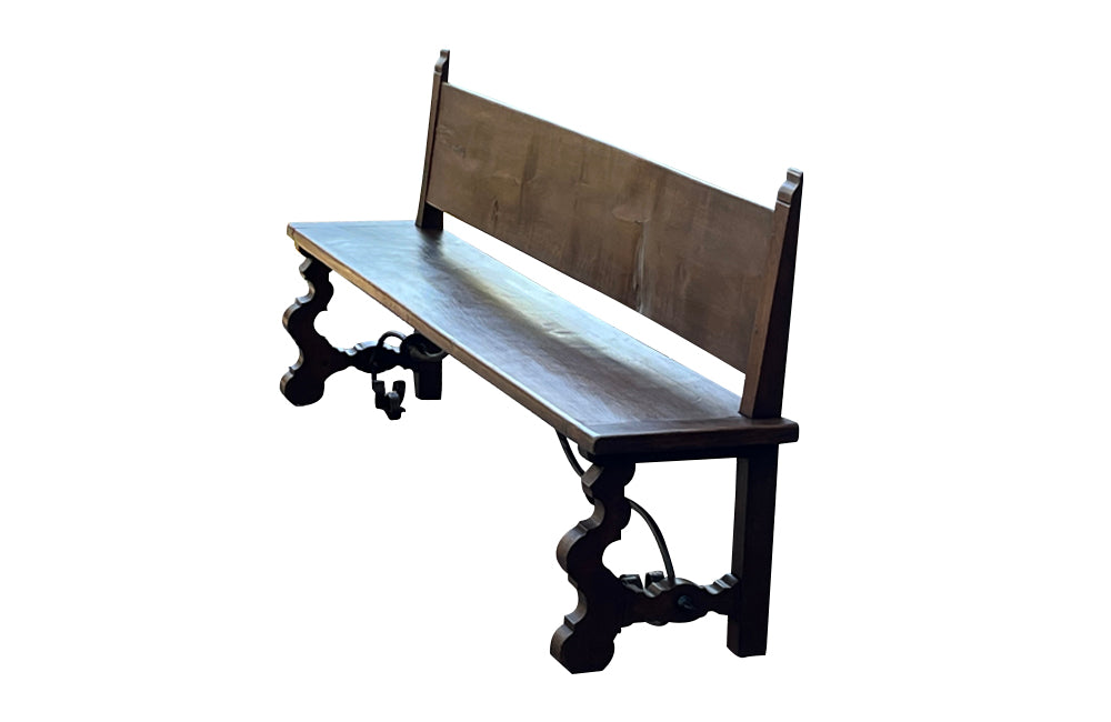 Pair of large Spanish oak benches with backs. Carved legs and decorative wrought iron stretchers.