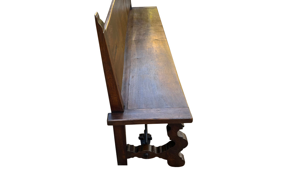 Pair of large Spanish oak benches with backs. Carved legs and decorative wrought iron stretchers.