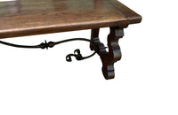 Pair of large Spanish oak benches with backs. Carved legs and decorative wrought iron stretchers.