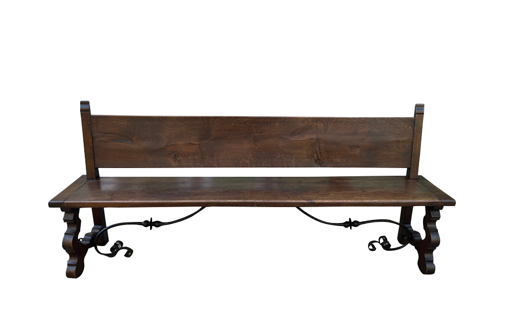 Pair of large Spanish oak benches with backs. Carved legs and decorative wrought iron stretchers.