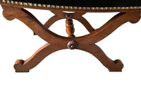 Oak x frame stool in the Neo-Classical style with spindle stretcher its charming tapestry depicting a Caribbean female figure. 19th century