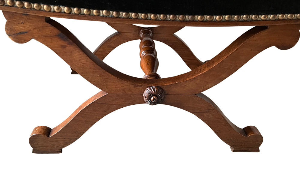 Oak x frame stool in the Neo-Classical style with spindle stretcher its charming tapestry depicting a Caribbean female figure. 19th century