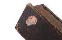 Charming French lidded file box in lovely old worn leather with Neo-Classical embossed motifs, including swans and urns . The base bears the original retail label of Au Bon Marche.