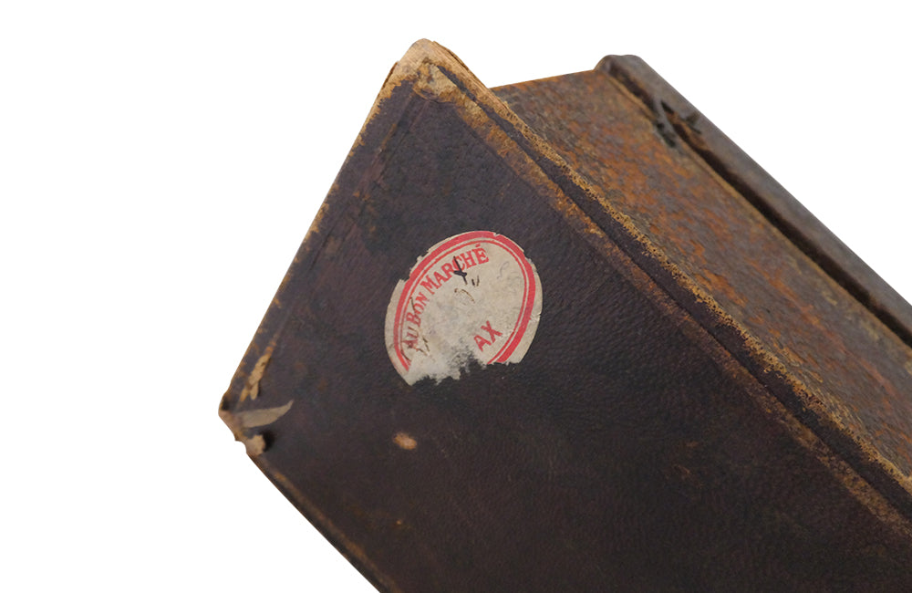 Charming French lidded file box in lovely old worn leather with Neo-Classical embossed motifs, including swans and urns . The base bears the original retail label of Au Bon Marche.