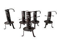 COLLECTION OF FIVE FRENCH IRON CELLAR CANDLESTICKS