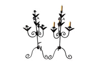 Pair of large wrought iron candle holders from a chateau in the Dordorgne. Tall decorative candlesticks with floral and foliate decoration and have 4 candle holders.