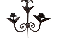 Pair of large wrought iron candle holders from a chateau in the Dordorgne. Tall decorative candlesticks with floral and foliate decoration and have 4 candle holders.