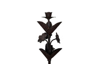 Pair of large wrought iron candle holders from a chateau in the Dordorgne. Tall decorative candlesticks with floral and foliate decoration and have 4 candle holders.