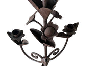 Pair of large wrought iron candle holders from a chateau in the Dordorgne. Tall decorative candlesticks with floral and foliate decoration and have 4 candle holders.