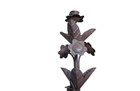 Pair of large wrought iron candle holders from a chateau in the Dordorgne. Tall decorative candlesticks with floral and foliate decoration and have 4 candle holders.
