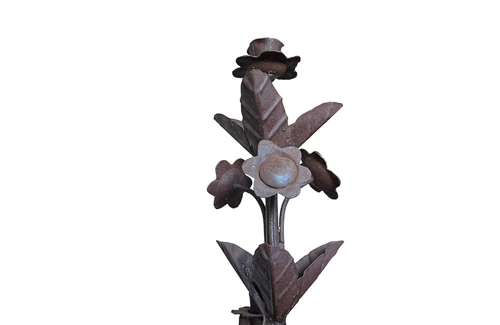 Pair of large wrought iron candle holders from a chateau in the Dordorgne. Tall decorative candlesticks with floral and foliate decoration and have 4 candle holders.