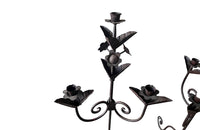 Pair of large wrought iron candle holders from a chateau in the Dordorgne. Tall decorative candlesticks with floral and foliate decoration and have 4 candle holders.