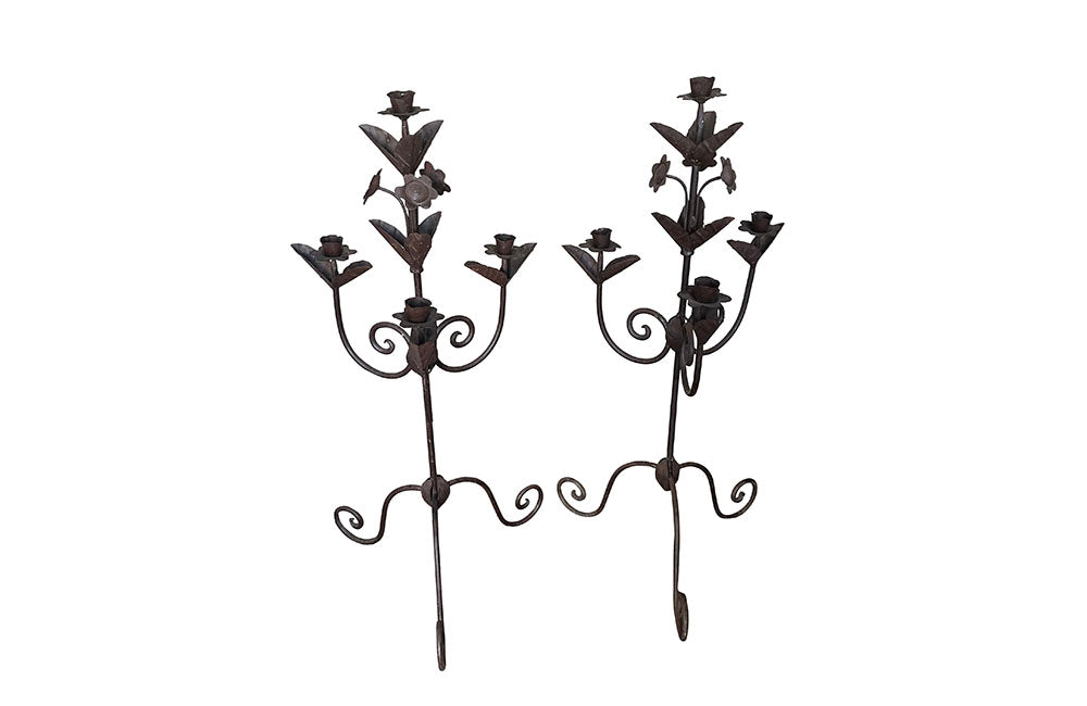 Pair of large wrought iron candle holders from a chateau in the Dordorgne. Tall decorative candlesticks with floral and foliate decoration and have 4 candle holders.