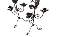 Pair of large wrought iron candle holders from a chateau in the Dordorgne. Tall decorative candlesticks with floral and foliate decoration and have 4 candle holders.