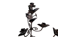 Pair of large wrought iron candle holders from a chateau in the Dordorgne. Tall decorative candlesticks with floral and foliate decoration and have 4 candle holders.