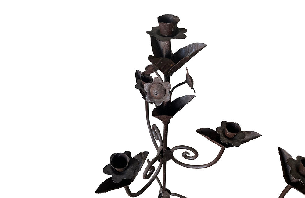 Pair of large wrought iron candle holders from a chateau in the Dordorgne. Tall decorative candlesticks with floral and foliate decoration and have 4 candle holders.