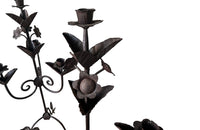 Pair of large wrought iron candle holders from a chateau in the Dordorgne. Tall decorative candlesticks with floral and foliate decoration and have 4 candle holders.