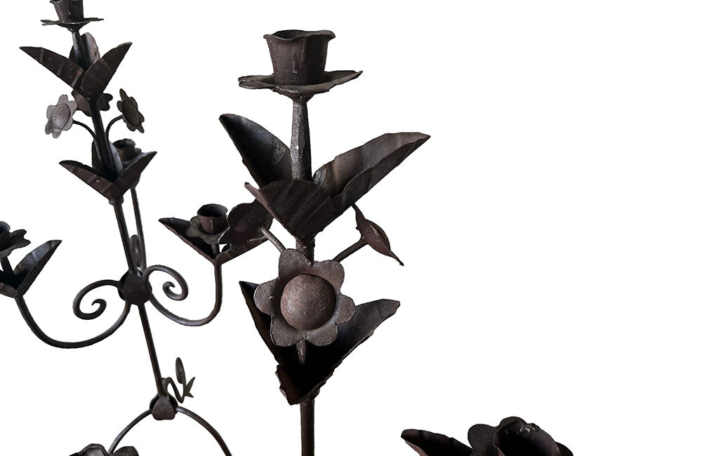 Pair of large wrought iron candle holders from a chateau in the Dordorgne. Tall decorative candlesticks with floral and foliate decoration and have 4 candle holders.
