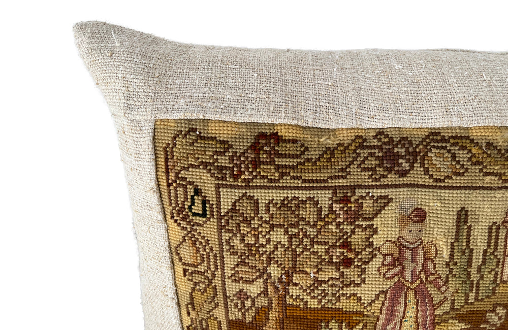 Charming cushion made with a 19th Century tapestry depicting a lady in the garden of a chateau with a duck.  It is feather filled and backed with lovely antique hemp fabric